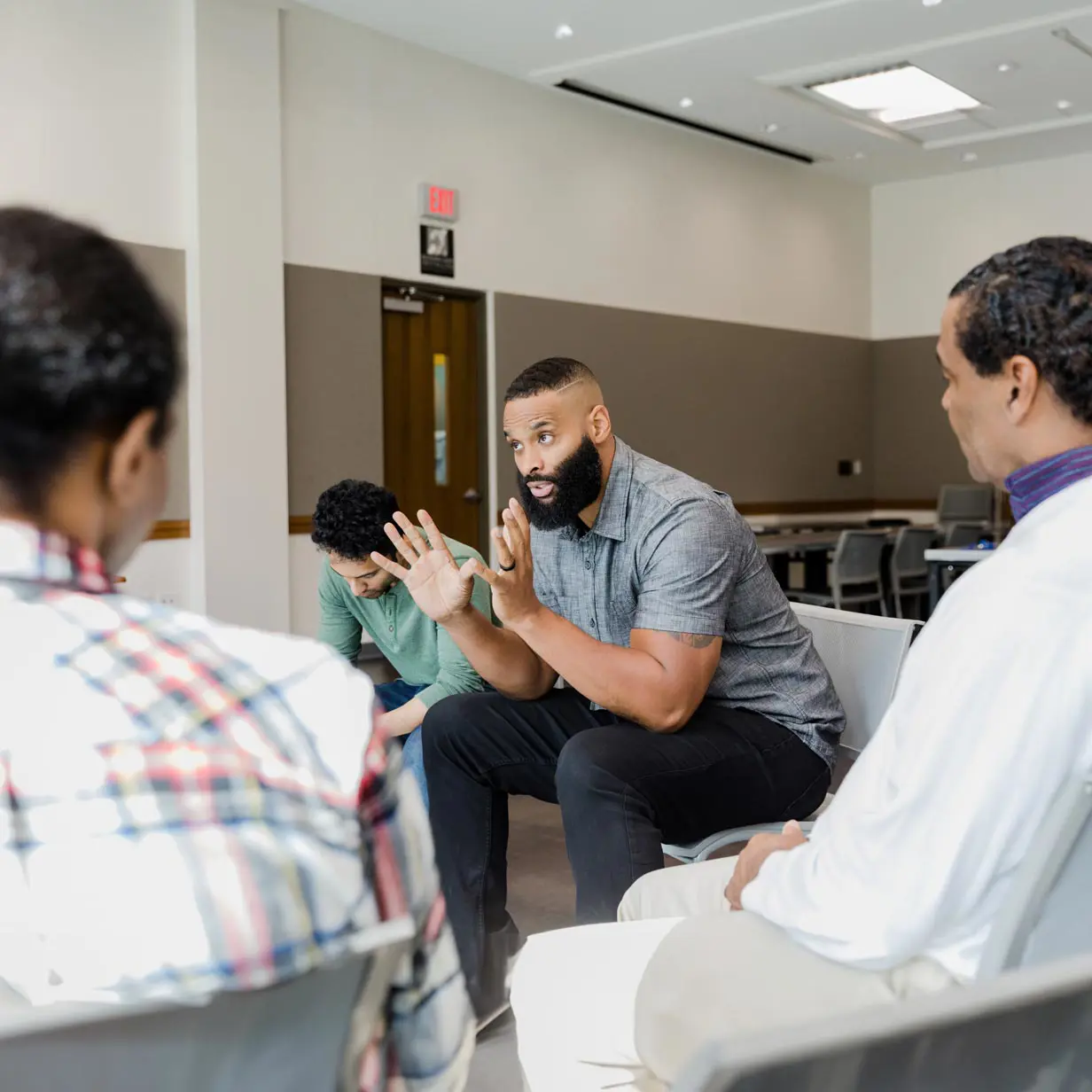 A man explaining something to a group of people.