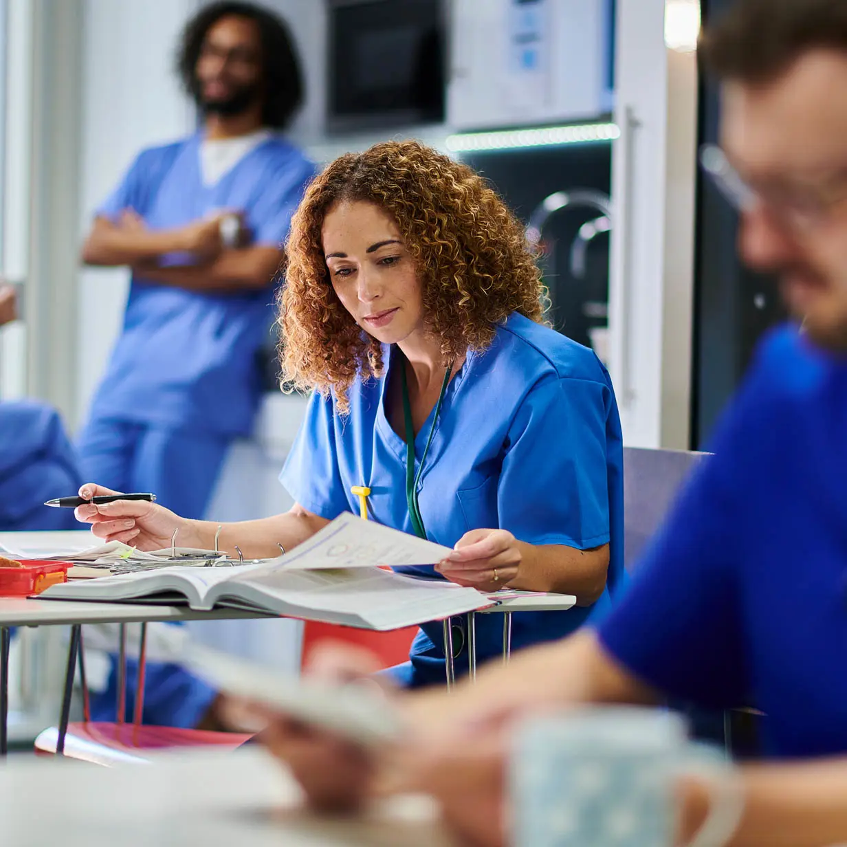 A medical professional looking through a binder.