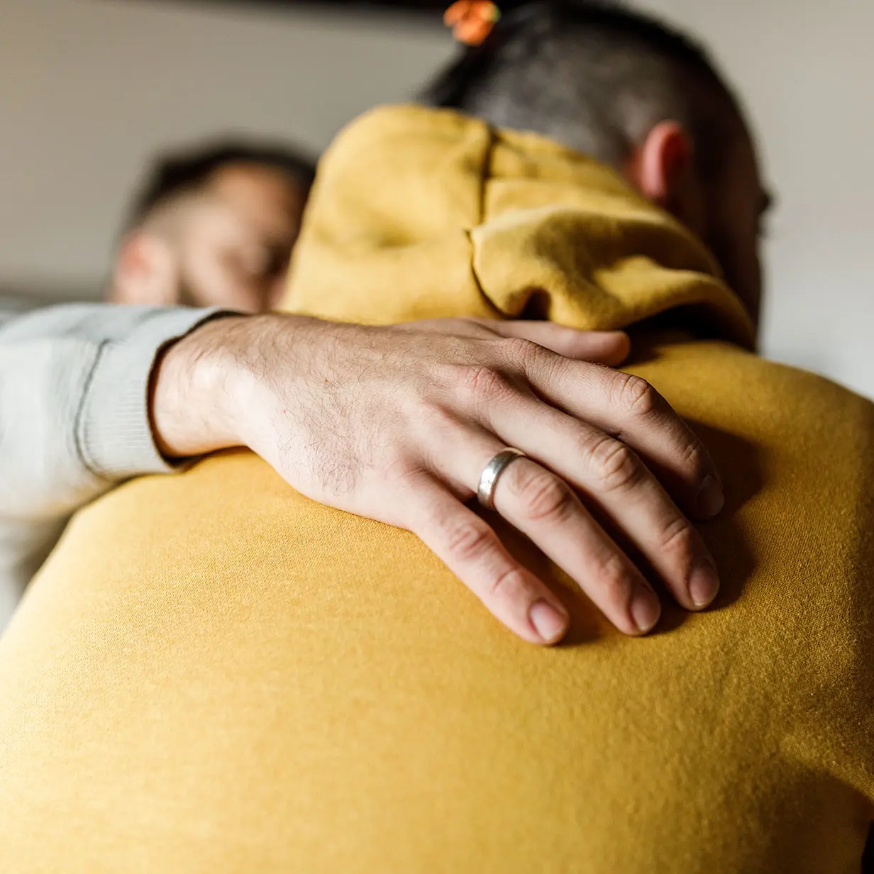 A man consoling another man.